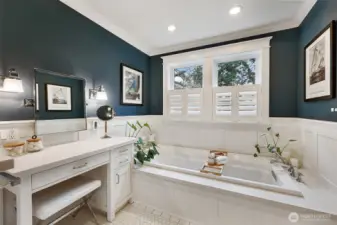 The sellers' 2-story addition on back of the home expanded this space (along with the kitchen) to accommodate this 6' soaking tub and seated vanity area (with laundry chute in the lower right of this vanity!)