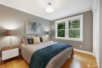 Third bedroom on the main level, overlooking the back yard for peaceful, treed views.