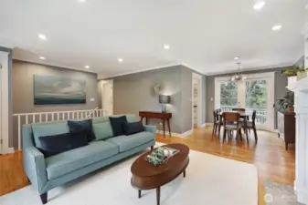 The sellers removed part of a non-load-bearing wall between the living room and stairs for openness, added overhead lighting & new trim, and transformed the space.