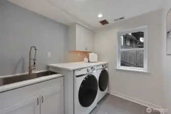 No creepy basement chores! Laundry day isn't so bad with a large utility sink, storage space, a folding shelf, and natural light.