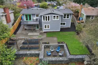 An aerial look at your backyard paradise. Pink and lavendar wisteria will soon be blooming on the arbor. (A fence could be added inside the gabion wall edge for young ones or pets).