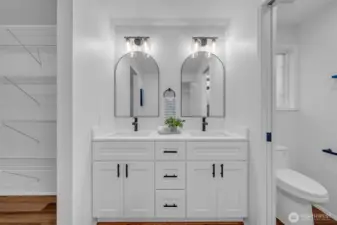 Completely remodeled primary bathroom with double vanity and walk-in shower