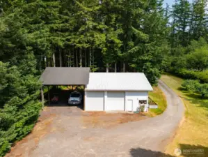 There is a lovely 2 bay shop with a work area and a large 2 vehicle (can accommodate most RV's) between the home and the road. There is a large raised bed with fresh vegetables.