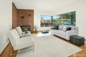 Large living room with beautiful original hardwoods that have been protected by carpeting for decades.