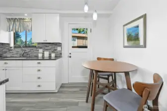 Keep the breakfast area or reconfigure the kitchen and add more cabinetry. Door leads to exterior walkway and carport.