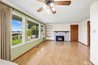 FAMILY ROOM  Wood burning certified fireplace insert with wood mantle, marble surround, and tile hearth  Built-in shelf / Ceiling fan