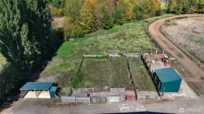 View of wash rack, cattle pens, shaving bin and manure storage area