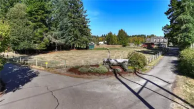 The well manicure garden beds greet you, as you pull into the Flying M Stables - to the right is the main residence and the drive to the left will take you to the arena/barn