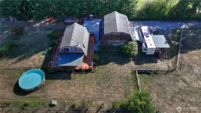 The residence - home, detached garage, established grounds, garden area, loads of fruit trees, pool & critter area!
