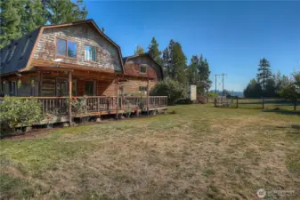 The Gambrel style architecture offer symmetry on both the house and detached garage. The established grounds around home features a variety of fruit trees, space for gardening and other critters.