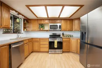 Kitchen with newer SS appliances - range, fridge & microwave