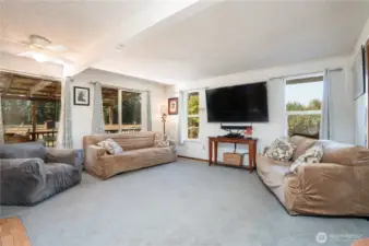 Living room with views of the deck and yard beyond