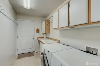 Spacious Utility Room with storage uppers, folding counter and utility sink for washing dirty hands after garage projects!