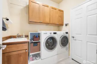 Spacious laundry room with a utility sink and room for organization.