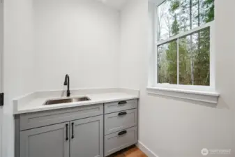 Main floor laundry off of the mudroom/garage area.