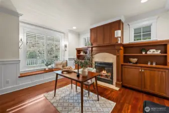 Just inside the entry you'll find this richly appointed den/office with a cozy fireplace and a window seat overlooking the front gardens.