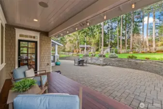 The architectural veranda transitions seamlessly to a huge cobblestone patio. Defined by a gently splashing water feature, it is the ultimate back yard BBQ party platform for large-scale entertaining.