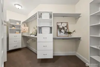 The primary walk in closet is a great example of the home's careful attention to storage throughout!  Not enough space in 40 photos to show that storage is abundant everywhere!  From the huge walk in pantry, mud room, butler's pantry, built ins galore, and over 730 additional finished, heated sf of storage or ?? space above the detached garage, you won't ever worry about storage here!