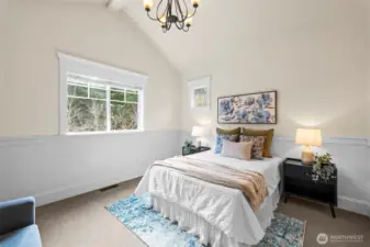 This bedroom with vaulted ceilings faces the front of the home and features a large walk in closet.