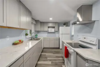 Fully updated kitchen with hardwood cabinets and quartz countertops.