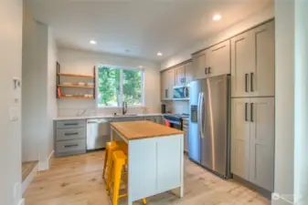 The spacious kitchen provides plenty of room for socializing, with ample space to move and gather comfortably.