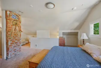 The brick chimney charm extends to the primary bedroom.