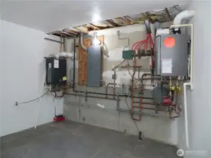 Part of the mechanical room with tankless water heater, electrical panel and radiant flooring controls for all of the upstairs.