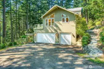 Exterior showing path to front door, and 3 car garage.