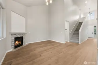 Looking across the family room, you can see how the home balances openness with privacy. The staircase and two story entry create a strong architectural moment, while the hallway leads past the coat closet and straight to the front door. Off to the side, the main floor primary suite sits in its own wing, which is exactly what you want if quiet matters. It’s an easy flow that feels intentional and surprisingly comfortable.