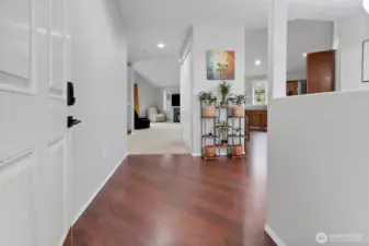 From the moment you enter, rich flooring and an open sightline create a seamless flow that immediately feels like home.