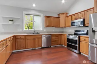 Abundant cabinetry, stainless appliances, and generous prep space invite everything from quick breakfasts to holiday baking.