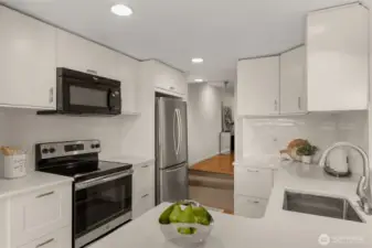 Kitchen with partial view of entry hallway