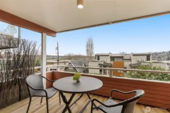 Expansive covered balcony with Lake Union views, perfect for relaxing or entertaining!