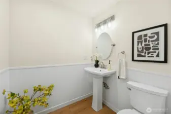 Main floor powder room just off the entry has been updated with new fixtures and lighting.