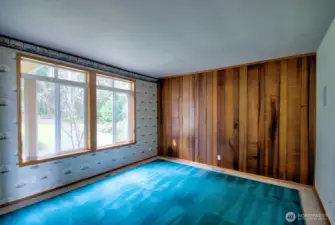 Off of the entryway, the den's wood paneling is reclaimed wood.