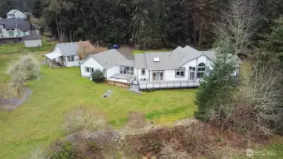 Aerial view of the home showing the deck, breezeway, attached garage, detached RV garage.