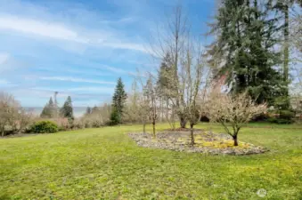 1.48 acre parcel affords a large, gently sloping backyard with a county road offering walking trail alongside.