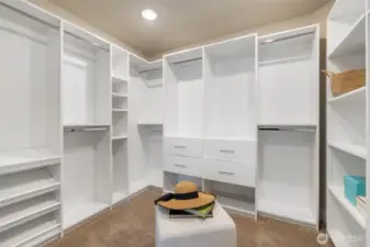 Upstairs primary bedroom walk-in closet with built-in shelving!