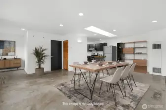 Large open concept living with industrial style concrete flooring. This photo has been virtually staged.