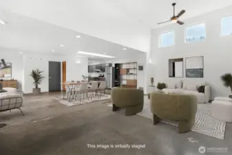 Large open concept living with industrial style concrete flooring. This photo has been virtually staged.