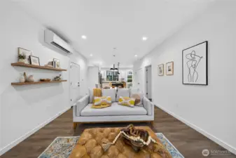 Looking from the fireplace back towards the dining and kitchen. Ductless mini splits offer energy efficiency as well as heating and cooling.