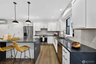 Island kitchen creates extra seating, plenty of upper/lower cabinetry for storage.