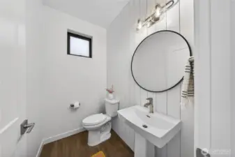 Main level powder room with matching shiplap wall feature.