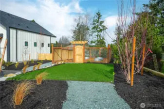 Community yard space with fenced garden.