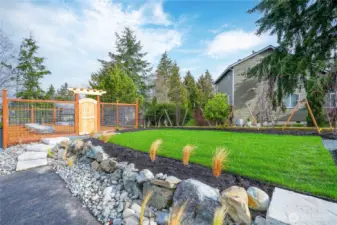 Community yard space just off the fenced garden is perfect for gathering with neighbors.