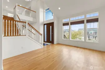 Living room. Bamboo window shades. Staircase leads up to 4 bedrooms including primary suite.