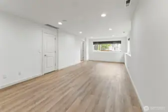 Lower level versatile suite with a bathroom and private entrance from the garage.