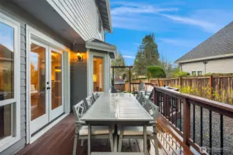 Dining area on back deck is adjacent to family room and kitchen.