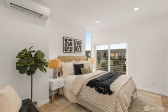 The primary suite is spacious with soft tones and balcony views and perfect for relaxation after a long day.