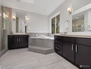 En-suite primary bathroom with soaking tub, dual vanities and separate shower.